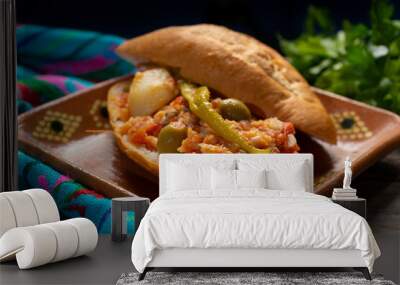 Mexican style cod sandwich called torta a la vizcaina on wooden background Wall mural