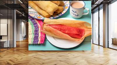 Mexican sweet tamales with strawberry jam on turquoise background Wall mural