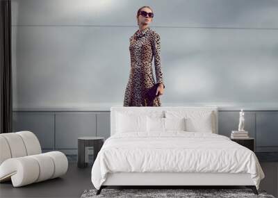 Elegant woman model in leopard dress walking in evening city, st Wall mural