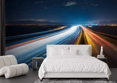 A long-exposure photo of a highway at night, showcasing vibrant streaks of light from moving vehicles against a dark backdrop. The image captures the dynamic motion and energy of the scene. Wall mural