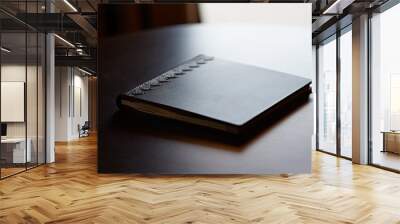 Note book with hard wooden cover on table by the window in natural light Wall mural