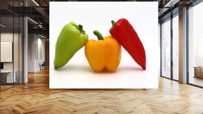 Three sweet peppers of yellow, red and green colors on a light background. Natural product. Natural color. Close-up. Wall mural