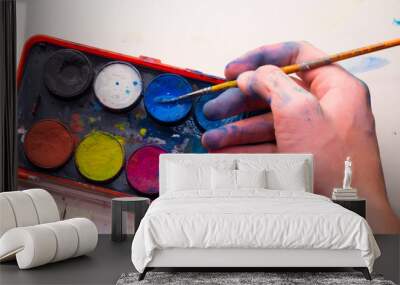 Caucasian Male artist hand using blue watercolor from palette Wall mural