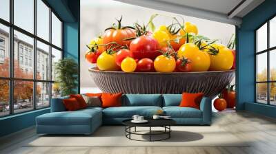 A bowl filled with a variety of fresh ripe tomatoes in different colors cherry tomatoes yellow pink brown and black sits beautifully on a smooth marble texture This organic vegetable harvest is the p Wall mural