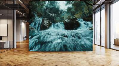 Blurred motion of a beautiful waterfall in natural landscape with trees and rushing water Wall mural