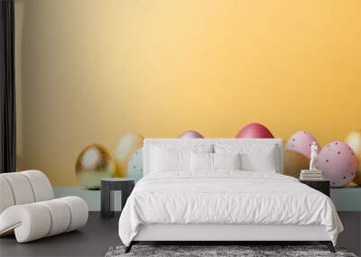 Creatively dyed decorative eggs in pastel colors decorated with gold leaf on yellow background copy space Happy Easter do it yourself concept Flat lay Horizontal Wall mural