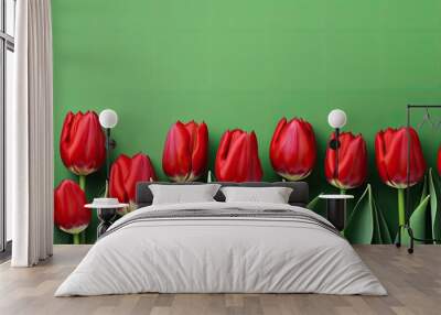 Layout of red bright tulips on a green background. copy space available Wall mural