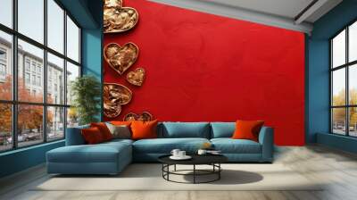 Valentine s Day concept with heart shaped gold paper cutouts on a vibrant red backdrop perfect for use as a copy space image Wall mural