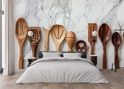 Wooden kitchen utensils displayed on a marble background with a focus on the concept of cooking and culinary art. Selective focus on a copy space image. Wall mural