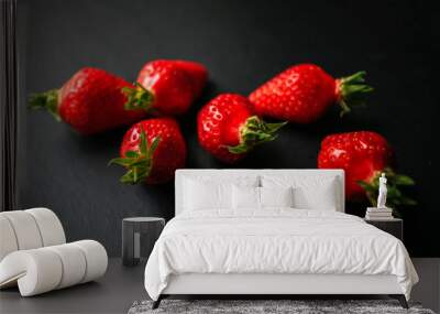 Group of delicious strawberrys on black background Wall mural