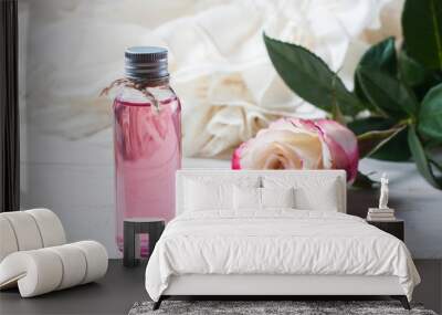 perfumed rose water in a bottle on a wooden table Wall mural