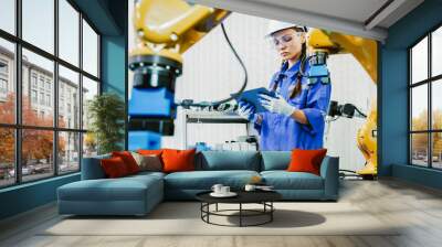 female automation machine engineer student study and inspection control robot arm machine in university or factory workshop. ai robot technology new innovation trend of manufacturing in industry 5.0 Wall mural