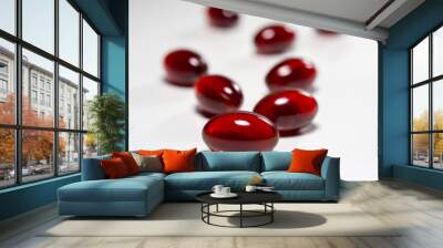 Krill oil capsules on white background. Translucent red softgel capsules of antarctic krill oil. Cardiovascular health. Nutritional supplement with valuable substances Wall mural