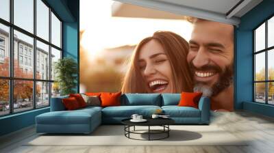 A cheerful couple shares a hearty laugh together in an outdoor setting Wall mural