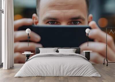 A close-up shot of an individual using a smartphone to take a picture, with focus on their hands and the phone, conveying modern interaction and technology. Wall mural