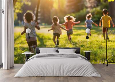 A group of diverse children play joyously in a sunlit park, running across the grass in a scene full of life and energy Wall mural