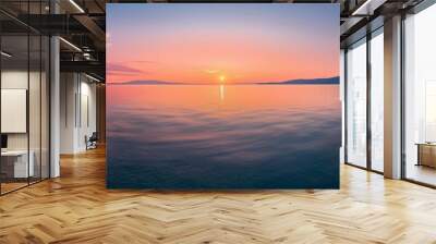 A stunning panoramic view of a tranquil sunset over the sea with a mountain silhouette on the horizon Wall mural