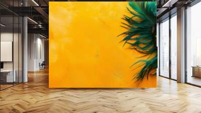 A vibrant green carnival mask adorned with feathers on a textured yellow background, capturing the essence of festivities Wall mural