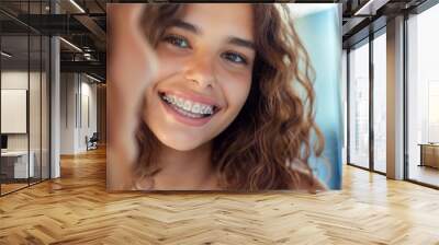 Cheerful teenage girl with braces smiling brightly, reflecting confidence and youth Wall mural