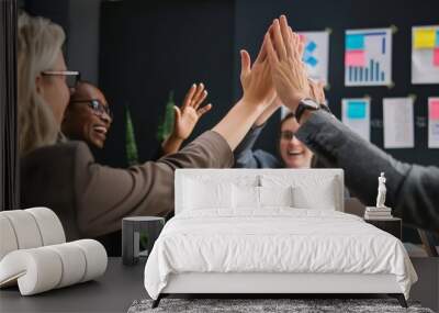 Professionals in a business setting energetically give high-fives in a collaborative celebration of success Wall mural