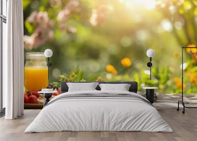 Sunlit outdoor breakfast with fresh fruit, juice, and pastries on a rustic wooden table Wall mural