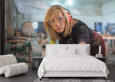 female carpenter using electric sander / female carpenter using electric sander for wood Wall mural