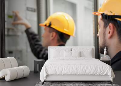 Field service crew testing electronics or inspecting electrical installation system Wall mural