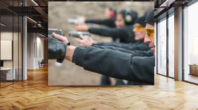 Group of civilian practice gun shooting on outdoor shooting range Wall mural