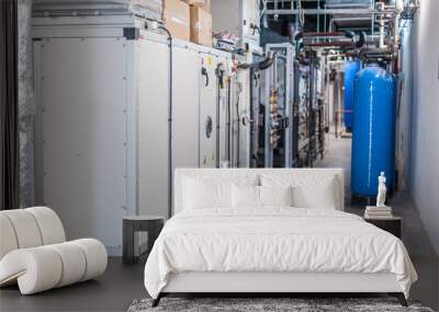 Huge industrial boiler services and air handling unit in the ventilation plant room with ductworks and insulated pipelines Wall mural