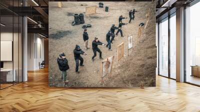 Students group with instructors practice gun shooting on shooting range Wall mural