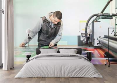 Technician works on large CNC computer numerical control cutting machine Wall mural