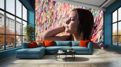 Girl in front of the grid with colored ribbons of Bonfim church in Salvador, Bahia, Brazil Wall mural