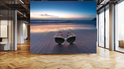 some sunglasses on a beach at sunset Wall mural