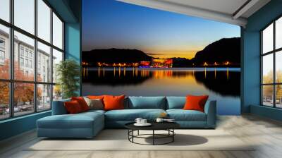 
We see a beautiful sunset next to the lake, with golden hills and the imposing four-star hotel Potrero de Los Funes in the background, in a calm and very colorful place, province of San Luis Arg. Wall mural