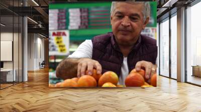 Man Choosing Tomatoes at Supermarket Wall mural