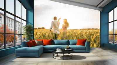 Romantic Couple Dancing on Love Moment at gold wheat field  Wall mural