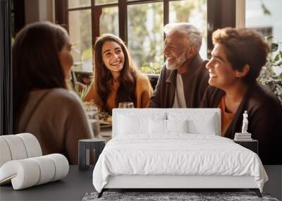 A multi-generational family laughing together during a weekend brunch, sun streaming through the windows highlighting the natural emotions, capturing the essence of familial bonds Wall mural