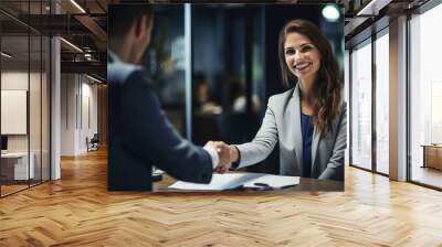 Happy mature business woman manager or lawyer handshaking client at office meeting. Smiling professional businesswoman and businessman shake having partnership agreement with handshake.  Wall mural