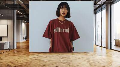 Stylish Woman in Maroon Editorial T-Shirt. Trendy woman with short hair and tattoos wearing a maroon 