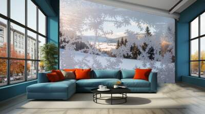 Frosty window pane with a scenic winter mountain view. Wall mural