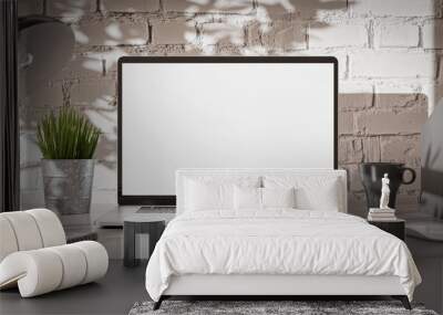 Laptop blank screen in a loft industrial office interior with brick wall Wall mural