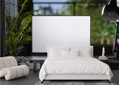 Laptop with blank frameless screen mockup template on the table in industrial office loft interior - front view Wall mural