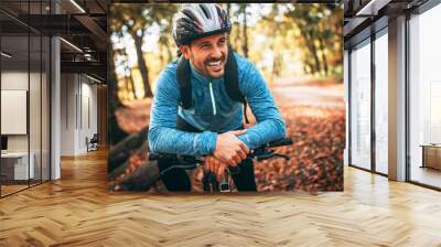 young man biking through forest Wall mural