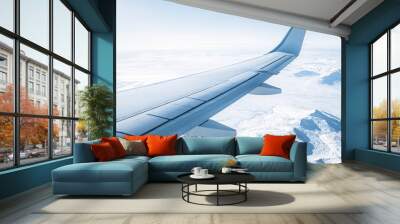 Airplane Wing Over Snowy Mountain Landscape Wall mural