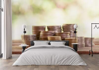 Rows of coins on wooden with nature background, Banking and finance background concept Wall mural