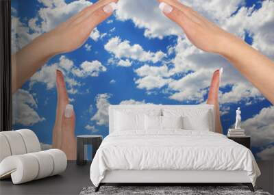 house made of female hands over blue sky Wall mural