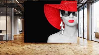 woman in red hat and sunglasses over black background Wall mural