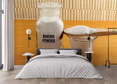 baking powder in bottle jar and wooden spoon Wall mural