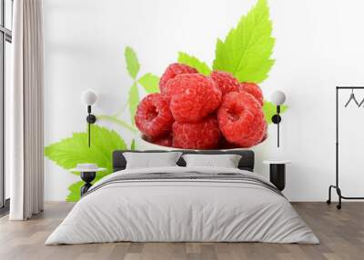 Ripe raspberry with leaf in bowl on white background Wall mural