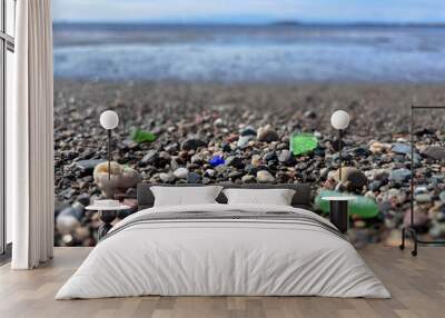 Seaglass in different colors among the pebbles on a beach along the Bay of Fundy, New Brunswick, Canada Wall mural